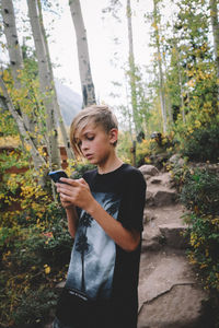 Teenage girl looking at camera in forest