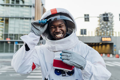 Portrait of smiling man standing in city