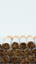 Close-up of cigarettes against white background