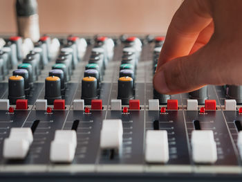 Cropped hand of male dj playing music on sound mixer