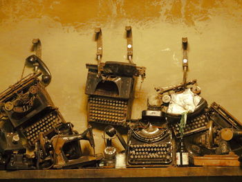 Close-up of old telephone on table against wall