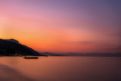 Scenic view of sea against romantic sky at sunset