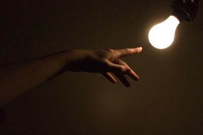 Person hand holding illuminated lamp