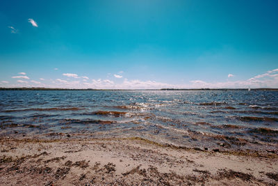 Scenic view of sea against blue sky