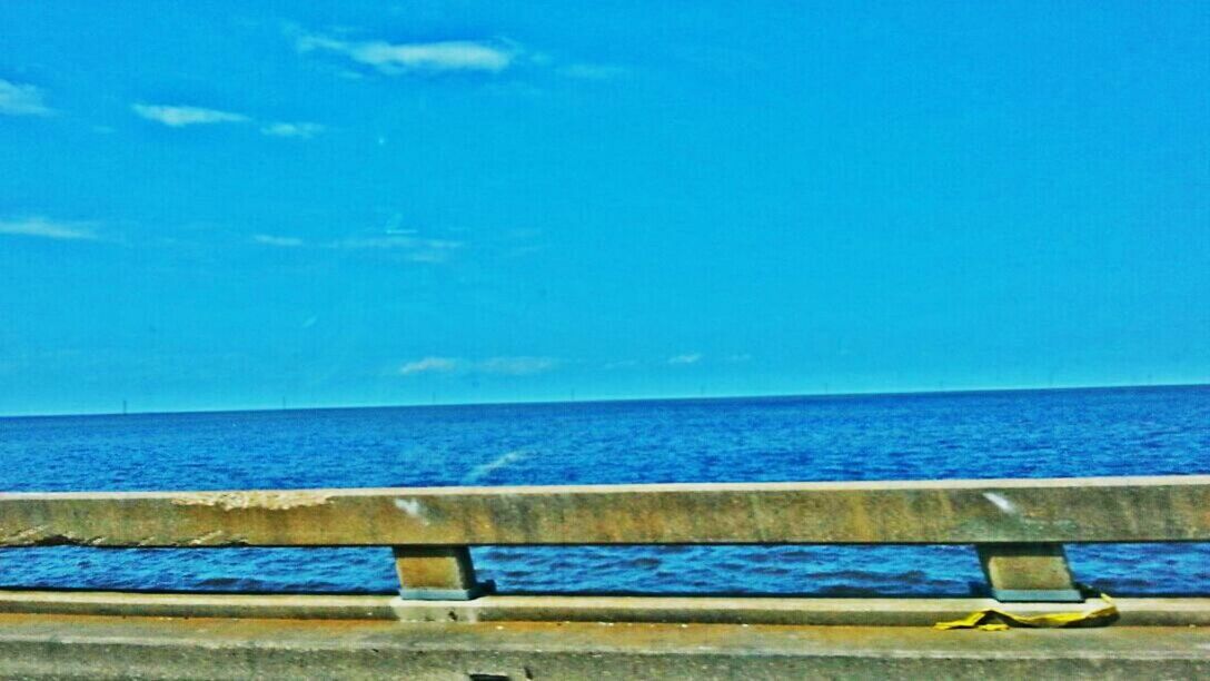 sea, horizon over water, blue, water, tranquility, tranquil scene, sky, copy space, scenics, beauty in nature, pier, nature, wood - material, railing, beach, idyllic, calm, outdoors, day, nautical vessel