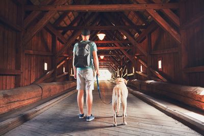 Rear view of man standing on bridge