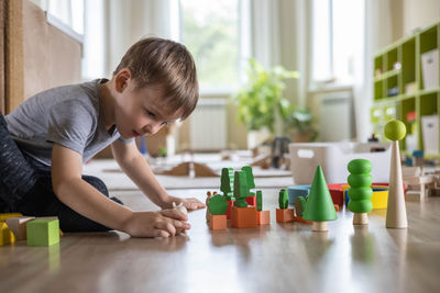 Boy playing with toy blocks at home