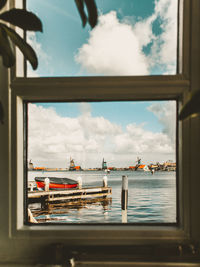 Panoramic view of sea against sky seen through window