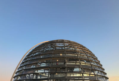 Low angle view of modern reichtags building against clear blue sky in berlin 