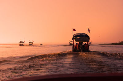 Scenic view of lotus sea against clear sky during sunrise