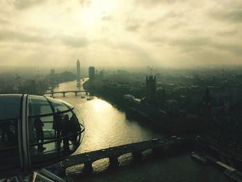 View of cityscape against cloudy sky