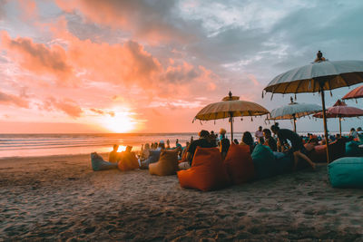 People at beach during sunset