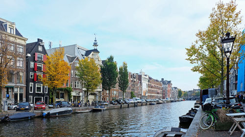 View of boats in city against sky