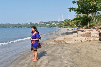 Full length of young woman on beach