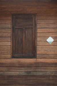 Close-up of closed wooden door of building