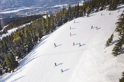 High angle view of people skiing on snowcapped mountain