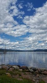 Scenic view of lake against cloudy sky