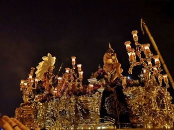 Low angle view of illuminated sculpture at night