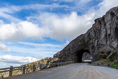 Road by bridge against sky