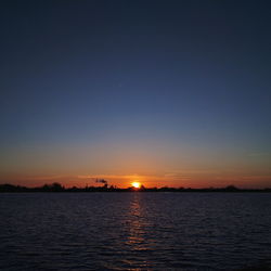 Scenic view of sea against sky at sunset