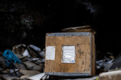 Close-up of old abandoned box on field