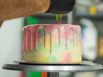 Cropped hand of man holding container