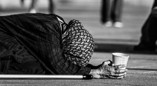 Close-up of woman begging on street