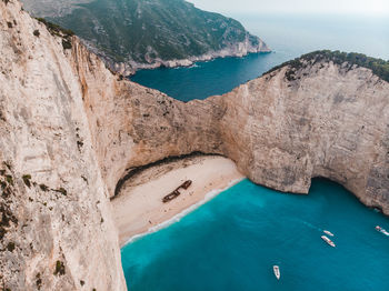 High angle view of rocks on sea shore