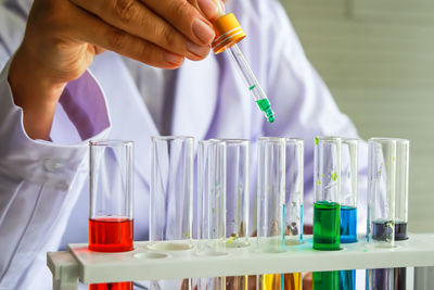 Close-up midsection of scientist doing research in lab