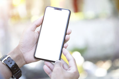 Close-up of hand holding mobile phone