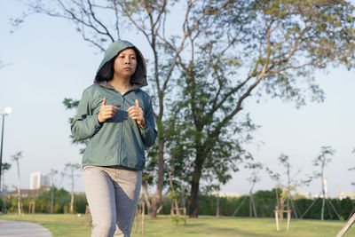 Woman looking away while jogging in park