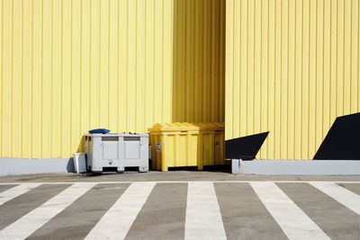 Garbage bins against wall on street