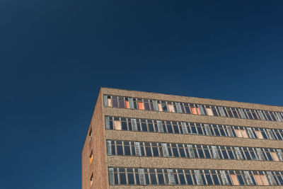 Low angle view of building against clear blue sky