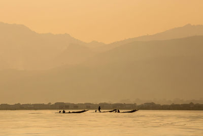 Scenic view of lake against sky during sunset