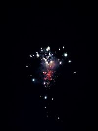 Low angle view of firework display at night