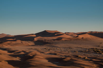 Scenic view of desert against sky during sunset