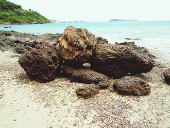 Rocks on beach against sky