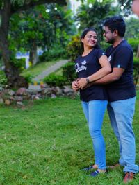 Young couple standing on field