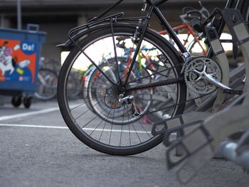 Close-up of bicycle parked on road in city