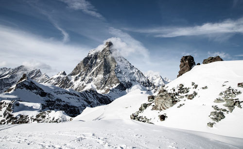 Scenic view of snow covered mountains against sky