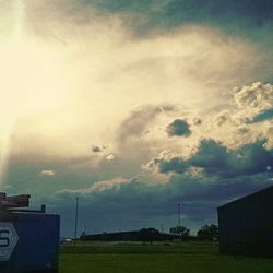 Scenic view of field against cloudy sky