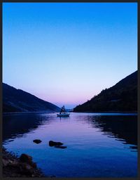 Scenic view of calm lake against clear sky