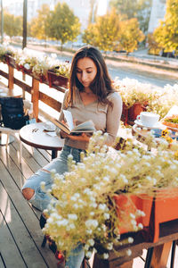 Portrait of beautiful woman reading a book while relaxing in the cafe.