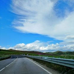 Road passing through landscape against sky