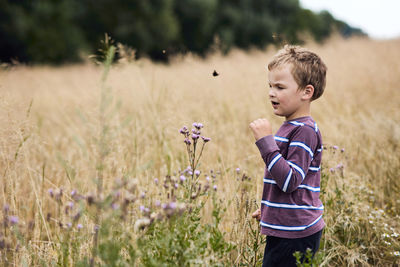 Boy standing on field