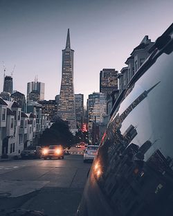 Buildings against sky during sunset in city