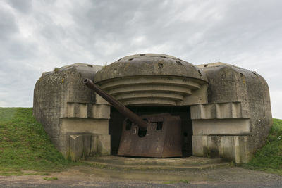 Built structure on field against sky