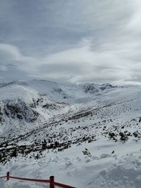 Scenic view of snow covered mountains against sky