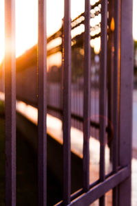 Close-up of metal gate against sky