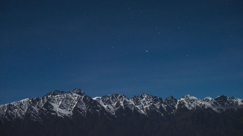 Low angle view of mountain against clear blue sky